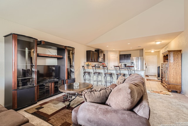 carpeted living room featuring lofted ceiling