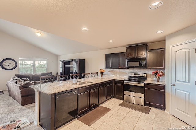 kitchen with sink, black appliances, vaulted ceiling, and kitchen peninsula