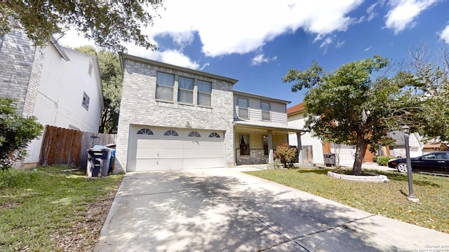 view of front of home featuring a front yard and a garage