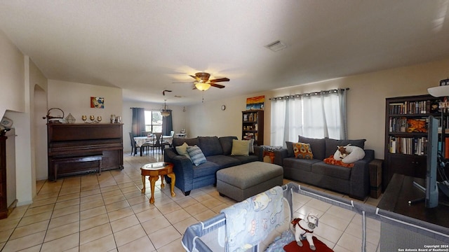 tiled living room featuring ceiling fan