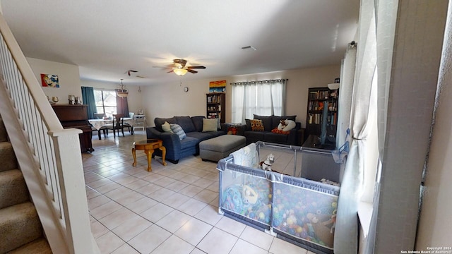 living room featuring ceiling fan and light tile patterned floors