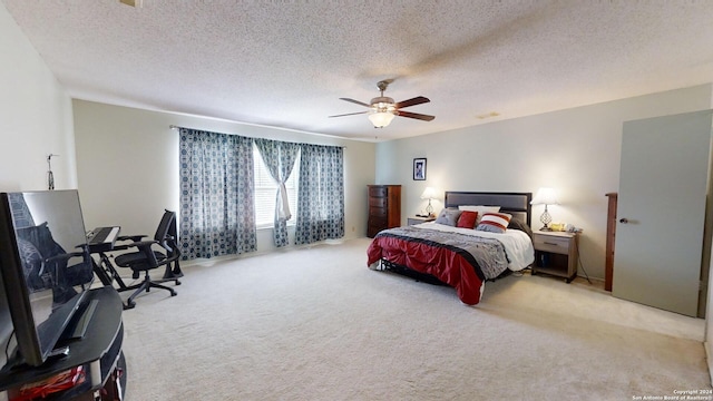 carpeted bedroom with a textured ceiling and ceiling fan