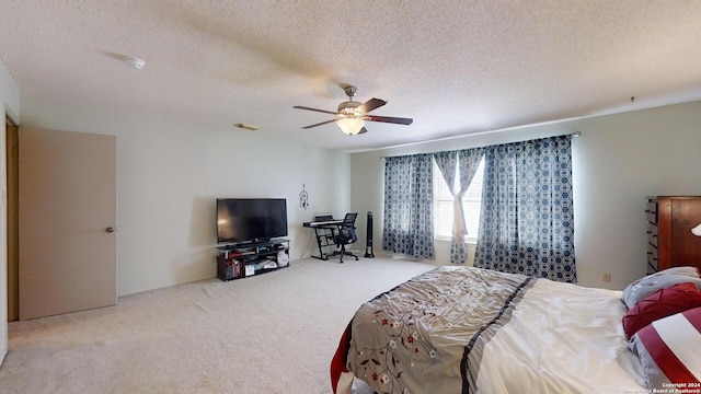 bedroom featuring a textured ceiling, carpet flooring, and ceiling fan