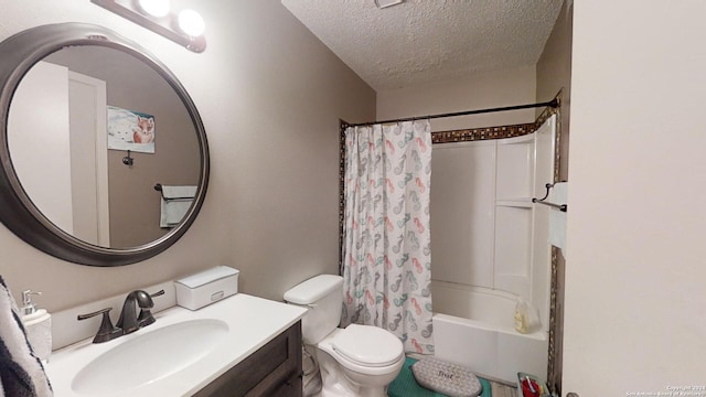 full bathroom featuring vanity, toilet, a textured ceiling, and shower / bath combo