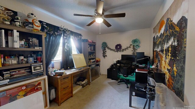 office space with light carpet, a textured ceiling, and ceiling fan