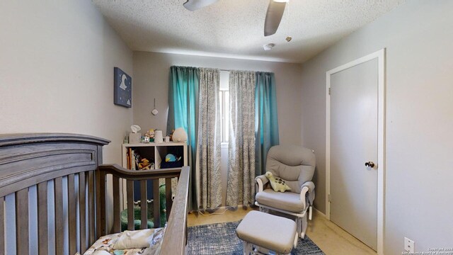 bedroom featuring carpet, ceiling fan, and a textured ceiling