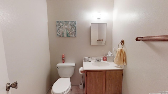 bathroom with toilet and vanity