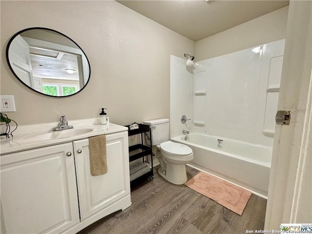 full bathroom featuring vanity, hardwood / wood-style floors, toilet, and shower / bathtub combination