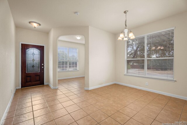 931 Palladio Pl, San Antonio, TX 78253 - foyer entrance featuring a chandelier, light tile patterned flooring, baseboards, and arched walkways