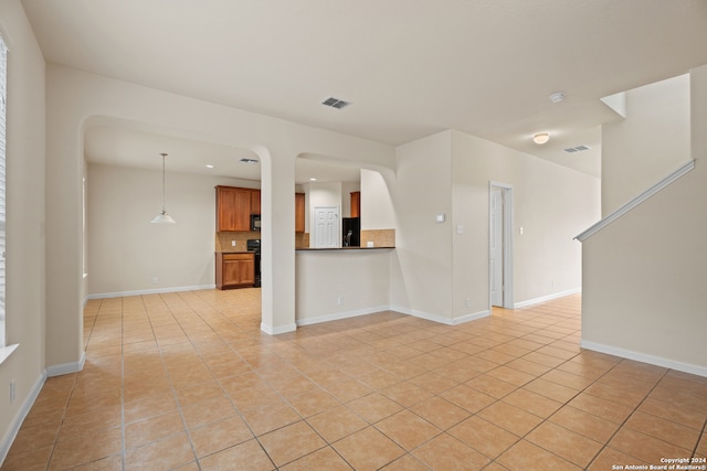 unfurnished living room with light tile patterned floors