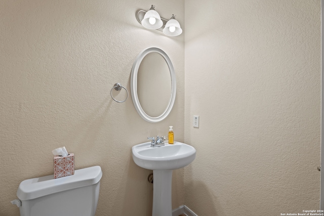 bathroom with toilet and sink