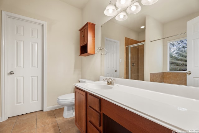 bathroom with a shower with door, toilet, tile patterned flooring, and vanity