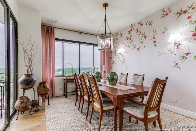 dining area featuring a chandelier and light wood-type flooring