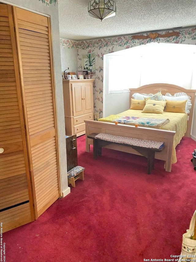 bedroom featuring a textured ceiling and carpet flooring