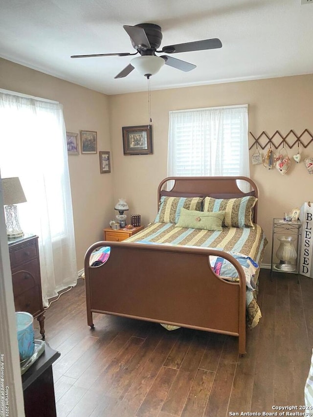 bedroom featuring ceiling fan and dark hardwood / wood-style flooring