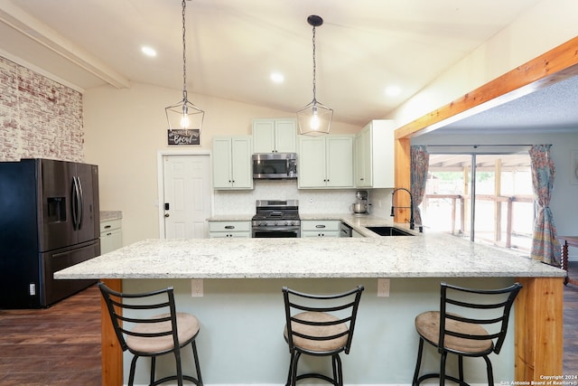 kitchen featuring sink, lofted ceiling with beams, white cabinetry, appliances with stainless steel finishes, and dark hardwood / wood-style flooring