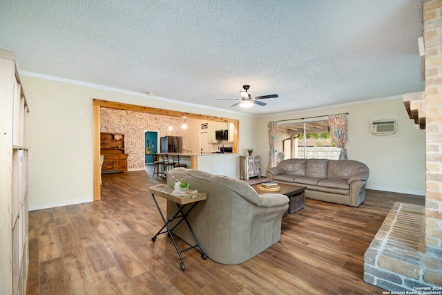 living room featuring hardwood / wood-style floors, crown molding, a textured ceiling, and ceiling fan