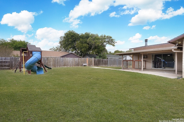 view of yard featuring a patio area and a playground