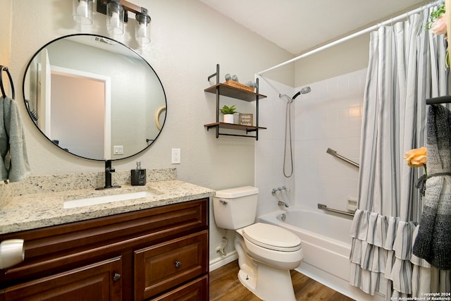 full bathroom featuring vanity, toilet, hardwood / wood-style flooring, and shower / tub combo