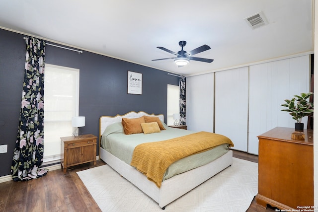 bedroom with dark hardwood / wood-style floors and ceiling fan