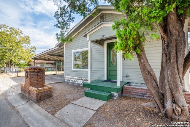 doorway to property with a carport