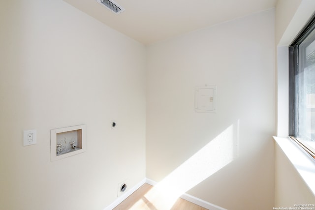 laundry room featuring light hardwood / wood-style floors, washer hookup, and electric dryer hookup