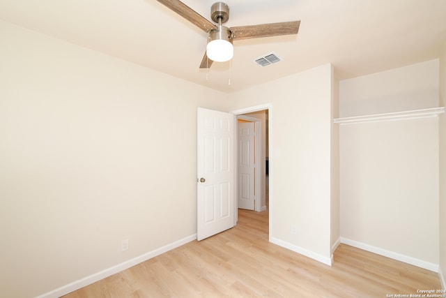 unfurnished bedroom with a closet, light wood-type flooring, and ceiling fan