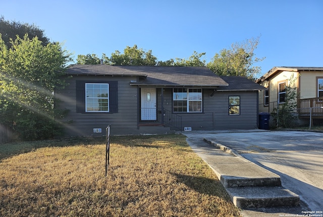 ranch-style house featuring crawl space, concrete driveway, and a front yard