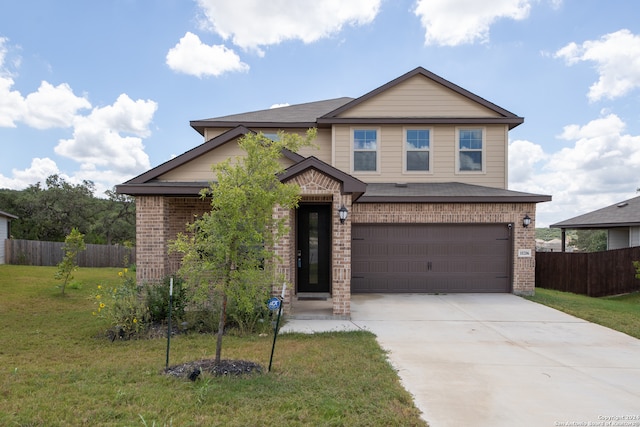 view of front of home with a front yard and a garage