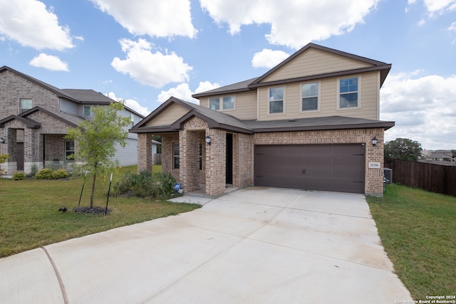 view of front of property with a front yard and a garage