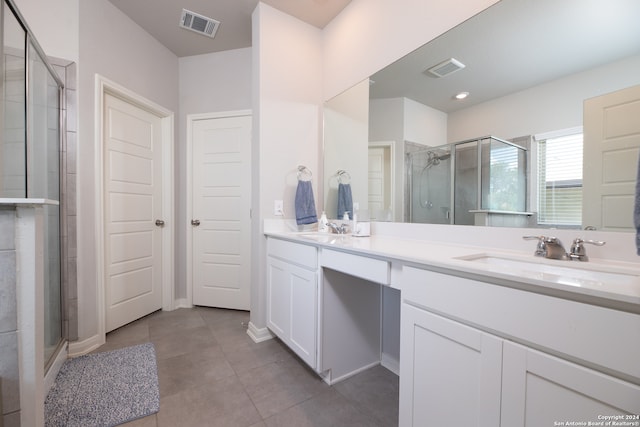 bathroom featuring vanity, tile patterned floors, and an enclosed shower