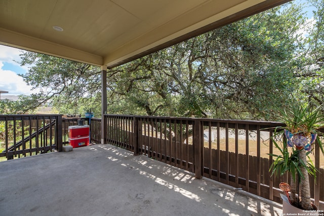 wooden balcony with a patio and a wooden deck