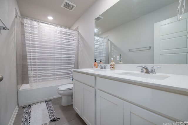 full bathroom featuring vanity, toilet, tile patterned floors, and shower / tub combo