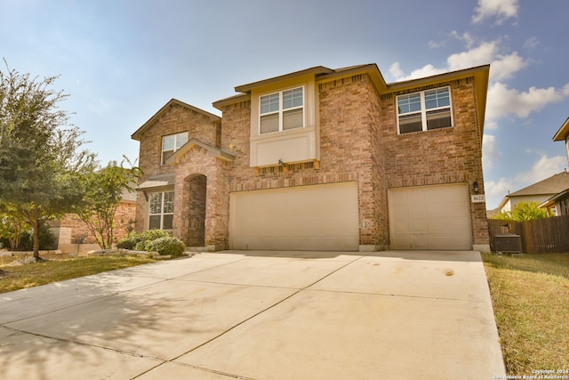 view of front of house featuring a garage and central air condition unit