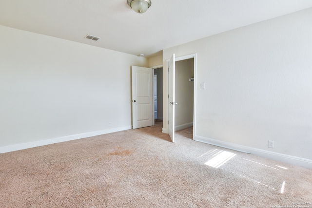 empty room featuring light carpet