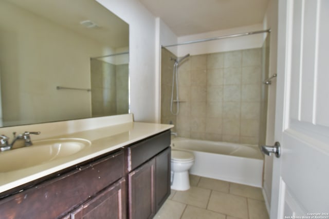 full bathroom with vanity, toilet, tiled shower / bath combo, and tile patterned flooring