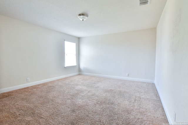 spare room featuring carpet