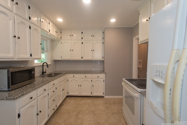 kitchen featuring white appliances, tasteful backsplash, light stone countertops, sink, and white cabinetry