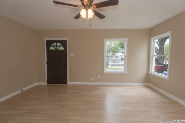 foyer entrance with light hardwood / wood-style flooring and ceiling fan