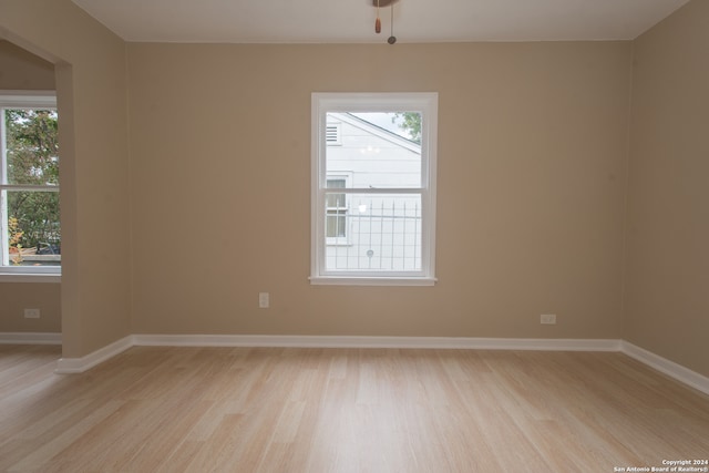 spare room with light hardwood / wood-style floors and ceiling fan