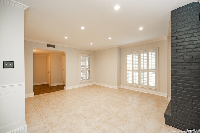 unfurnished living room featuring ornamental molding and a healthy amount of sunlight