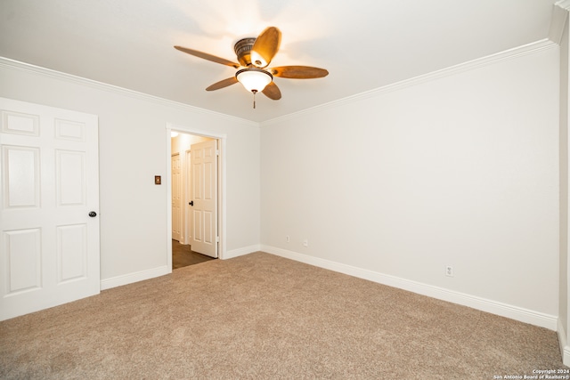 unfurnished bedroom featuring ornamental molding, carpet flooring, and ceiling fan