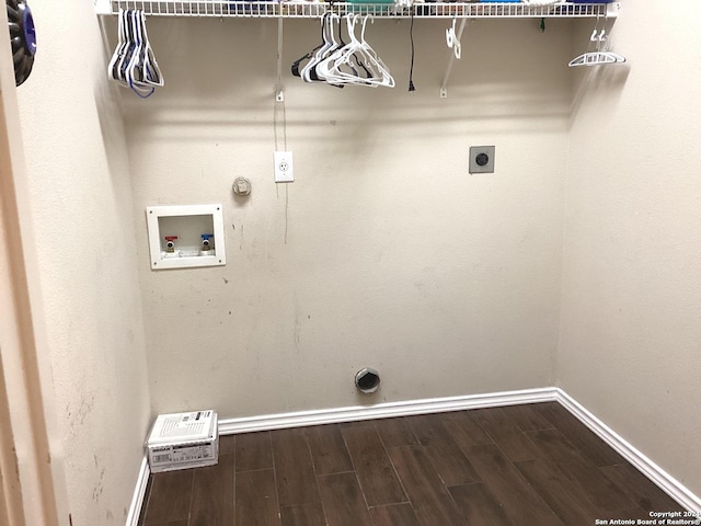 washroom with hookup for an electric dryer, hookup for a gas dryer, dark wood-type flooring, washer hookup, and baseboards