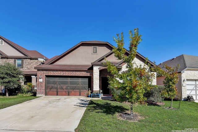 view of front of home featuring a front yard and a garage