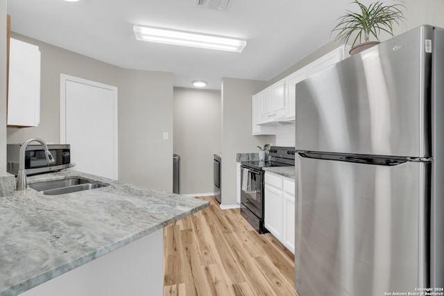 8722 Ridge Moon Dr, San Antonio, TX 78239 - kitchen featuring stainless steel appliances, white cabinetry, light wood finished floors, and light stone countertops