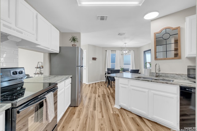 kitchen with light hardwood / wood-style floors, white cabinetry, black appliances, and sink