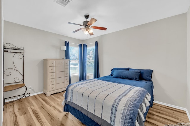 8722 Ridge Moon Dr, San Antonio, TX 78239 - bedroom with wood finished floors, baseboards, and ceiling fan