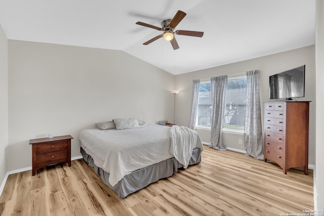 bedroom featuring light hardwood / wood-style floors, lofted ceiling, and ceiling fan