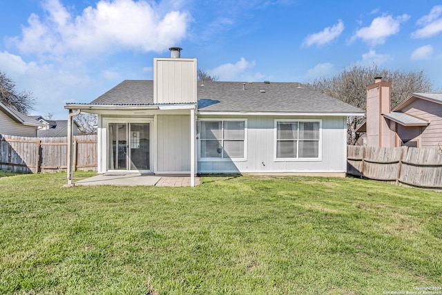 rear view of house with a yard and a patio