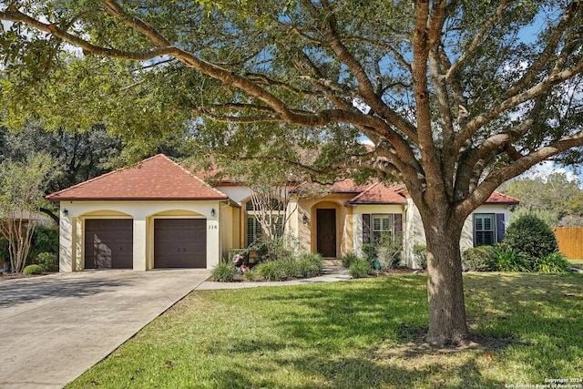 view of front of property featuring a front lawn and a garage